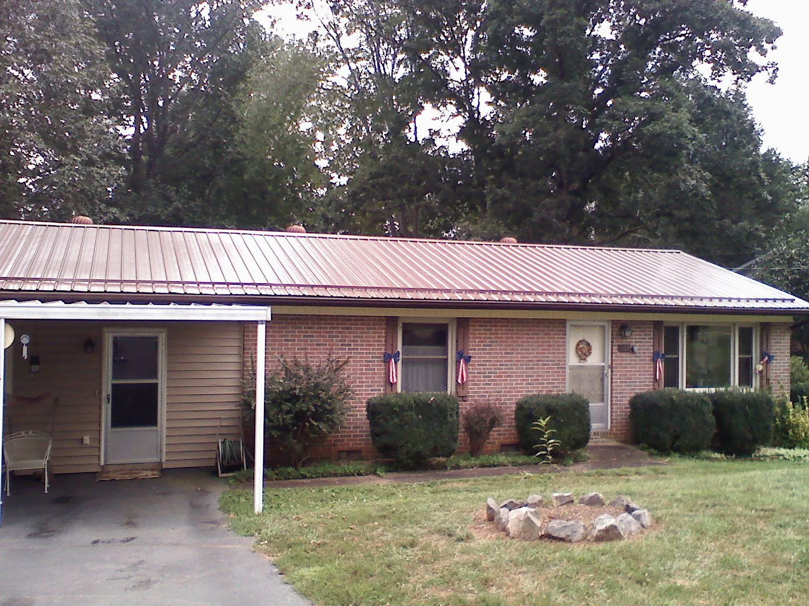 Bronze metal roof and carport on a brick ranch home — Roof Repair work by our crew in Camas
